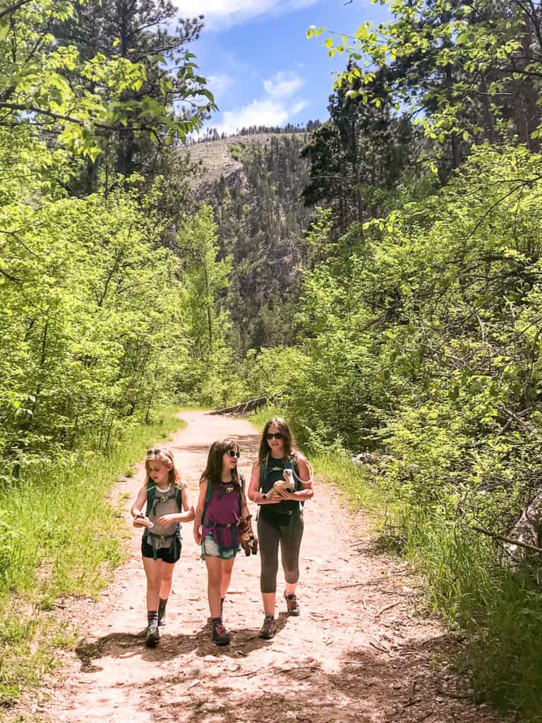 Three young girls on a wooded trail