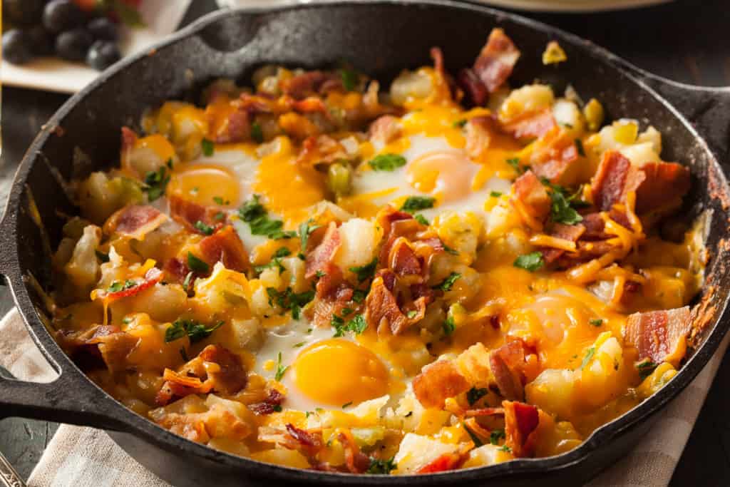 Breakfast skillet with eggs, potatoes and bacon in a cast iron pan